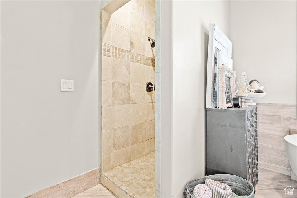 Bathroom with a tile shower and a freestanding bath