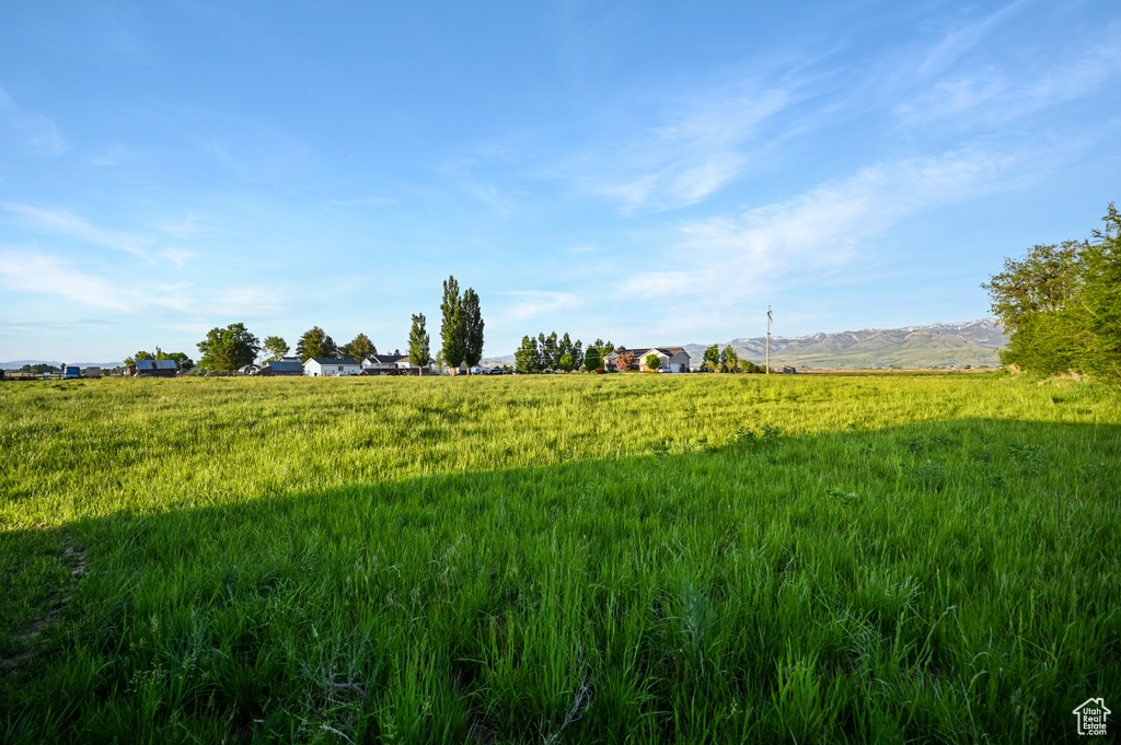 View of undeveloped land featuring mountains and rural landscape