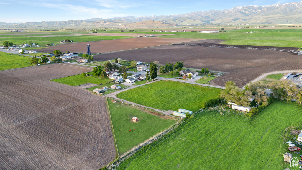 Aerial overview of property\'s location with a mountainous background and rural landscape