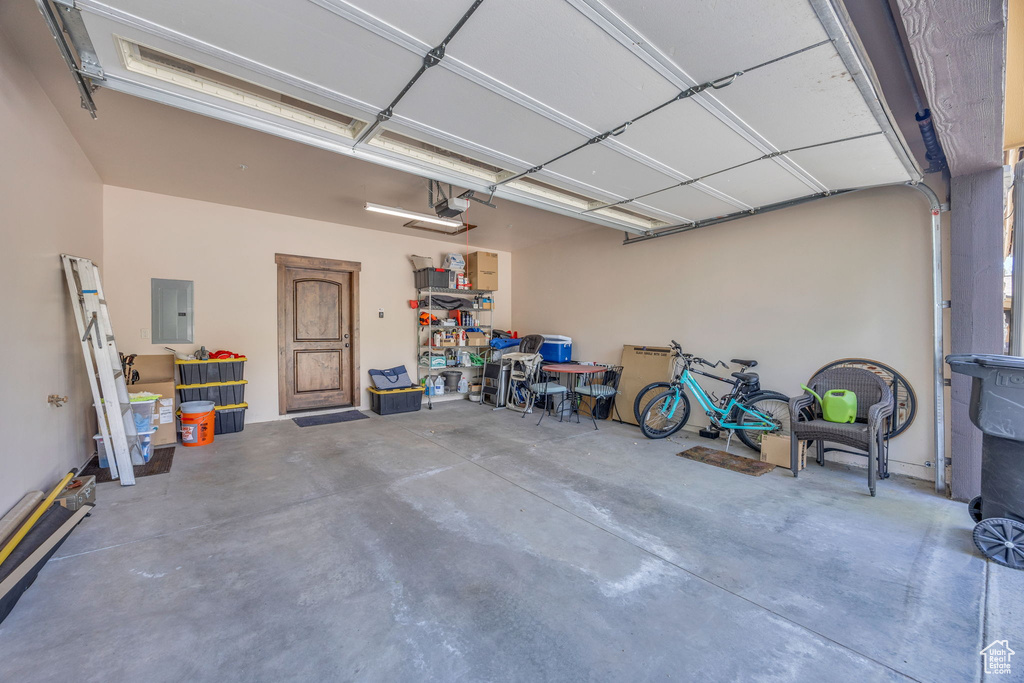 Garage with electric panel and a garage door opener