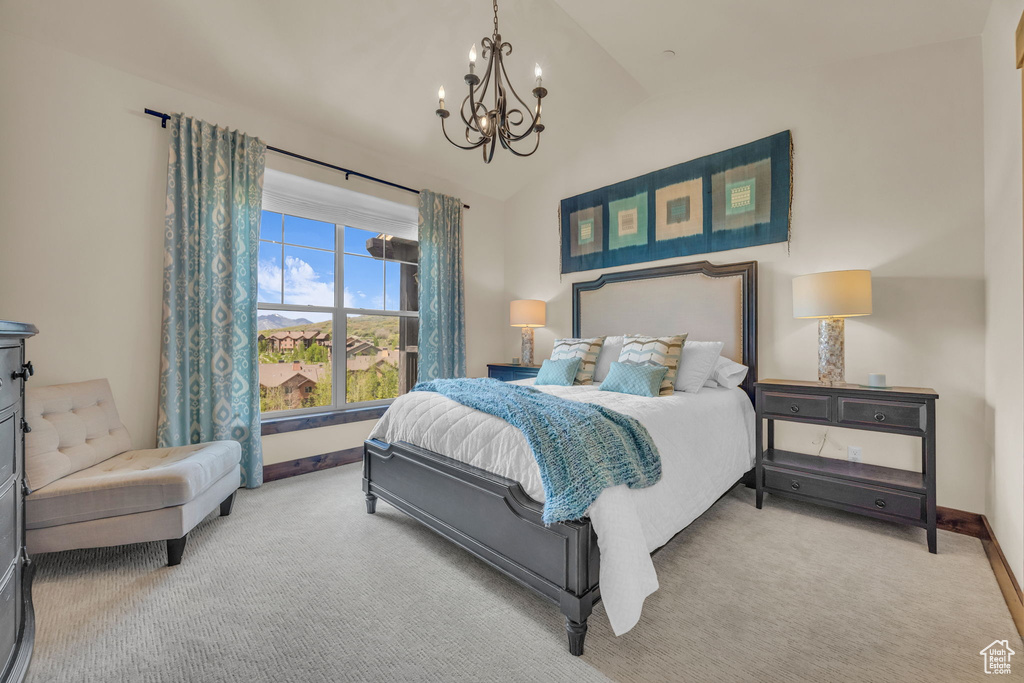 Bedroom with a chandelier, carpet floors, baseboards, and vaulted ceiling