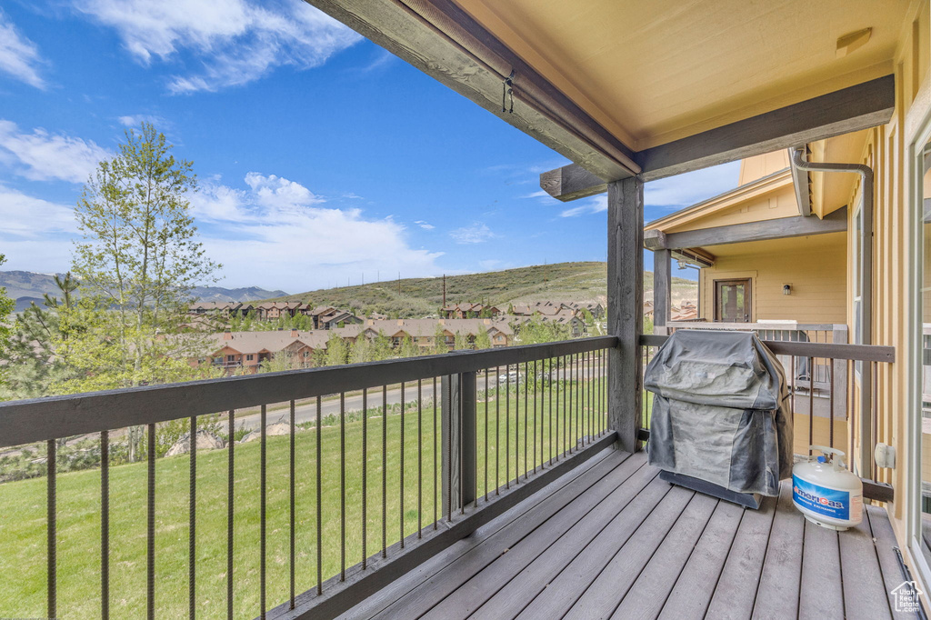 Wooden terrace with a mountain view and a lawn