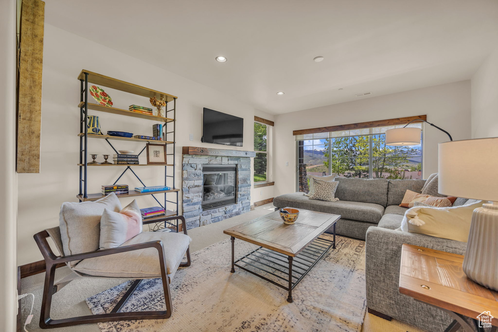 Living area featuring a fireplace, recessed lighting, and baseboards