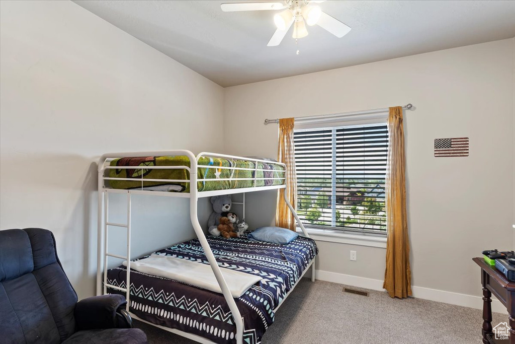 Bedroom with carpet, baseboards, and a ceiling fan