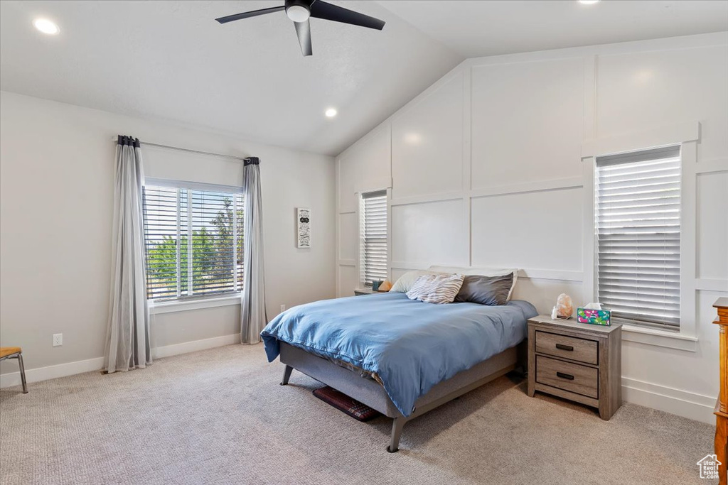 Bedroom with lofted ceiling, light colored carpet, a ceiling fan, baseboards, and recessed lighting