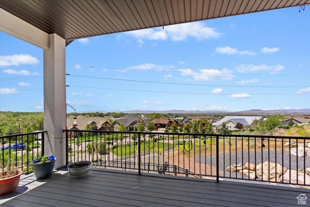 Wooden deck featuring a residential view and a mountain view