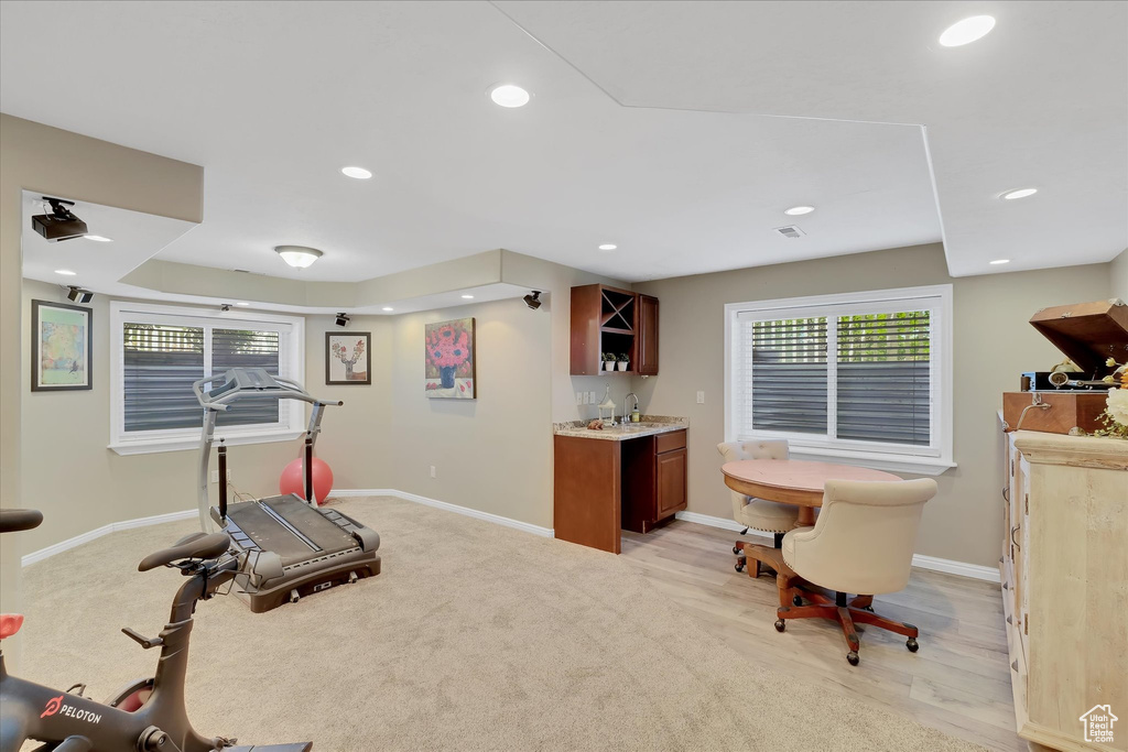 Exercise room featuring a bar, baseboards, healthy amount of natural light, and recessed lighting
