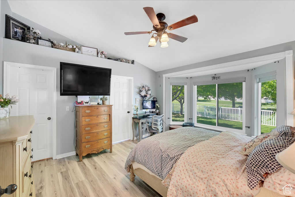 Bedroom with access to exterior, light wood-style flooring, lofted ceiling, ceiling fan, and baseboards