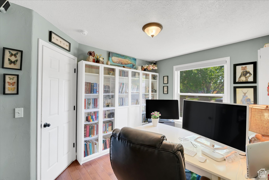 Office space featuring a textured ceiling and hardwood / wood-style flooring