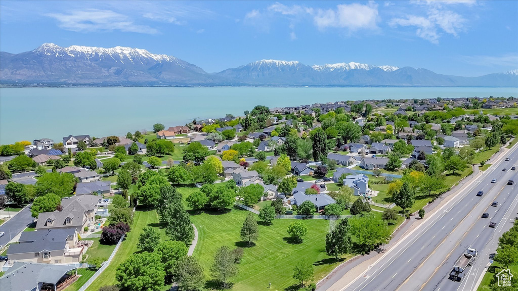 Aerial perspective of suburban area with a main thoroughfare and a water and mountain view
