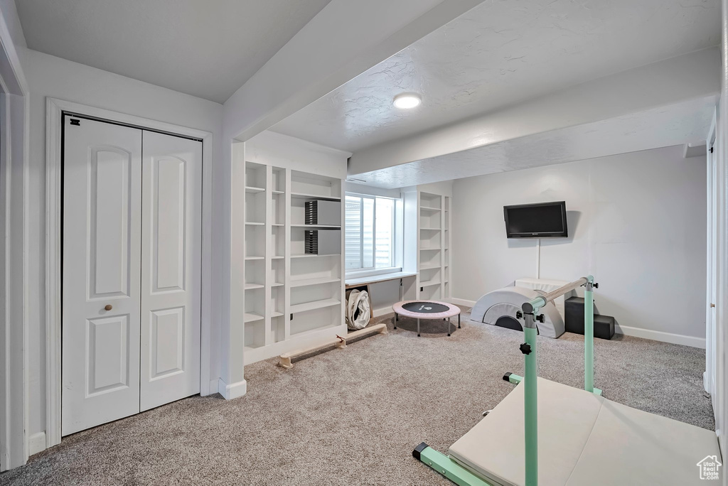 Workout room with carpet and baseboards