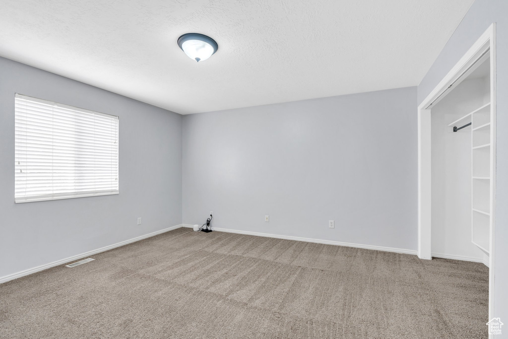 Unfurnished room featuring carpet flooring and baseboards
