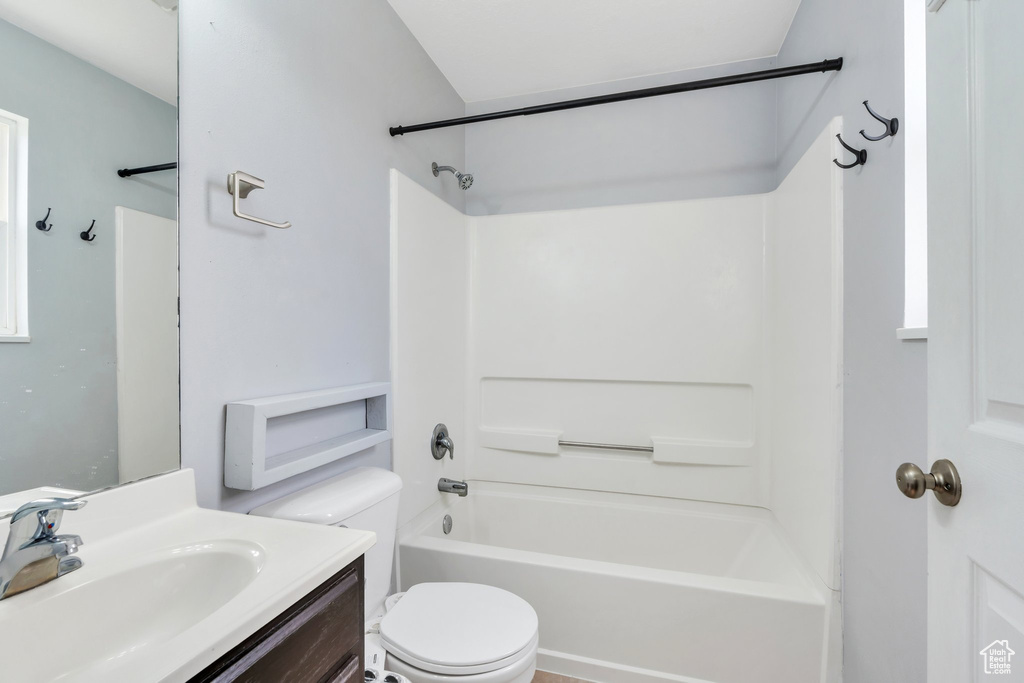 Full bathroom featuring toilet, vanity, and bathing tub / shower combination
