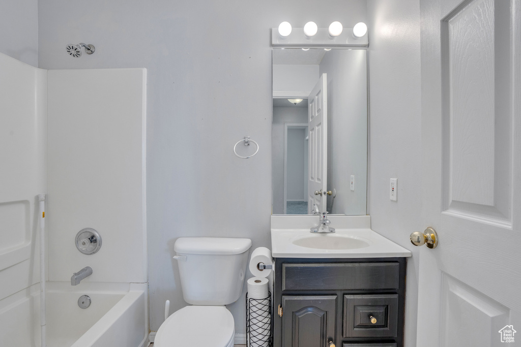 Bathroom with vanity, toilet, and shower / tub combination