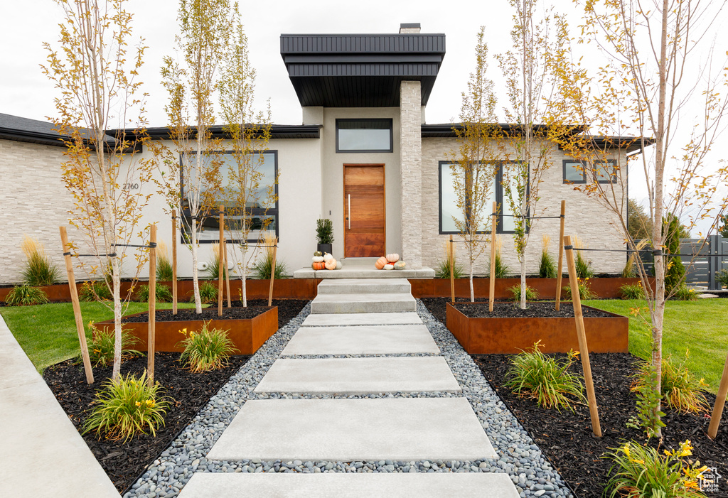 Property entrance with stucco siding