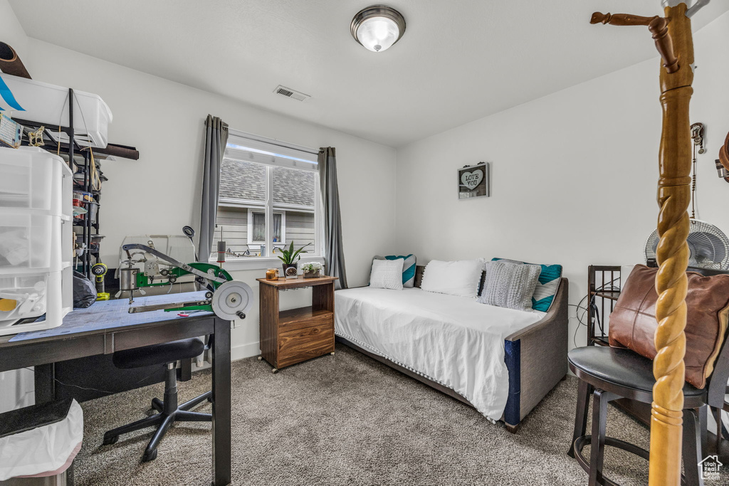 Bedroom with carpet and an office area