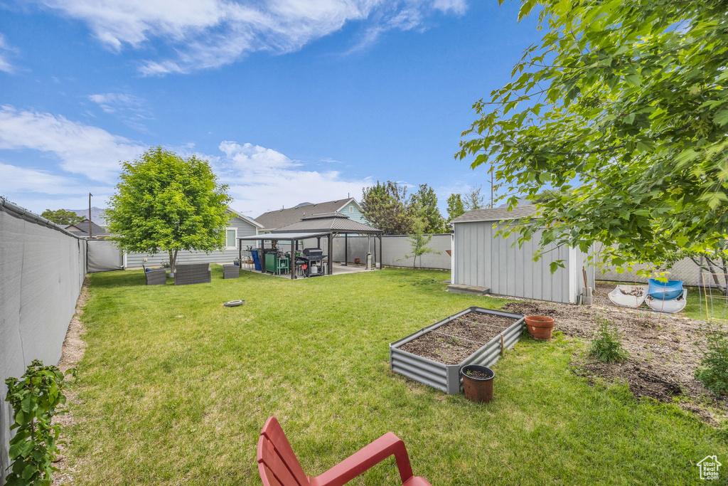 View of yard featuring a gazebo and a vegetable garden
