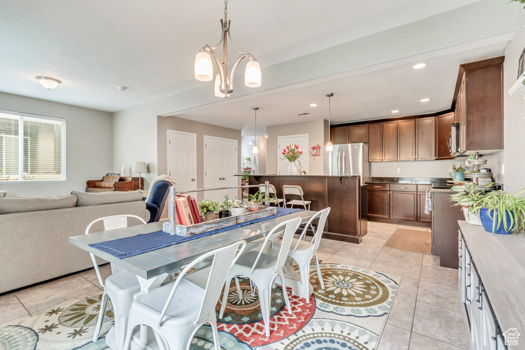 Dining area with recessed lighting and light tile patterned floors