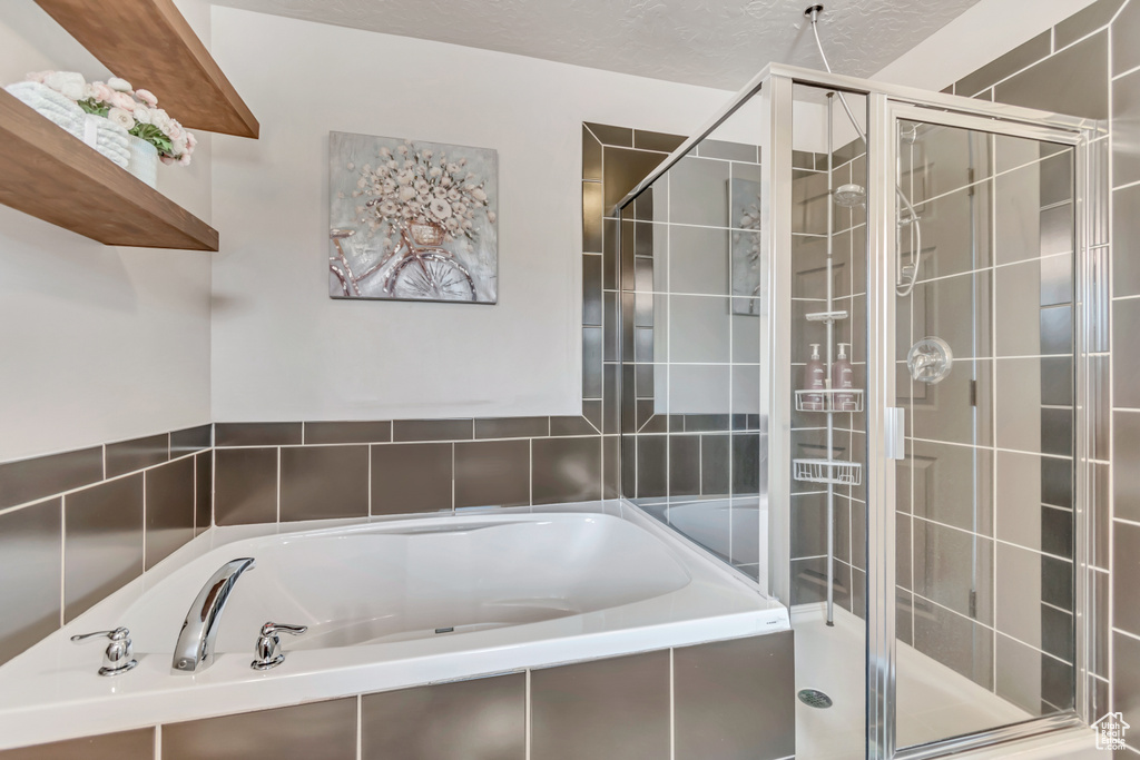 Bathroom with a bath and a shower stall
