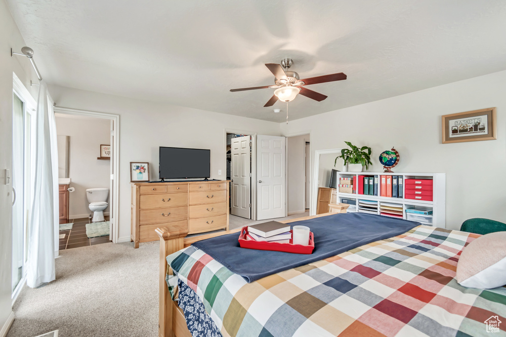 Bedroom with light carpet, ensuite bathroom, a ceiling fan, and a closet