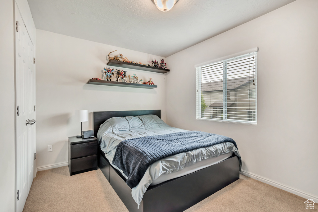 Bedroom with carpet floors and baseboards