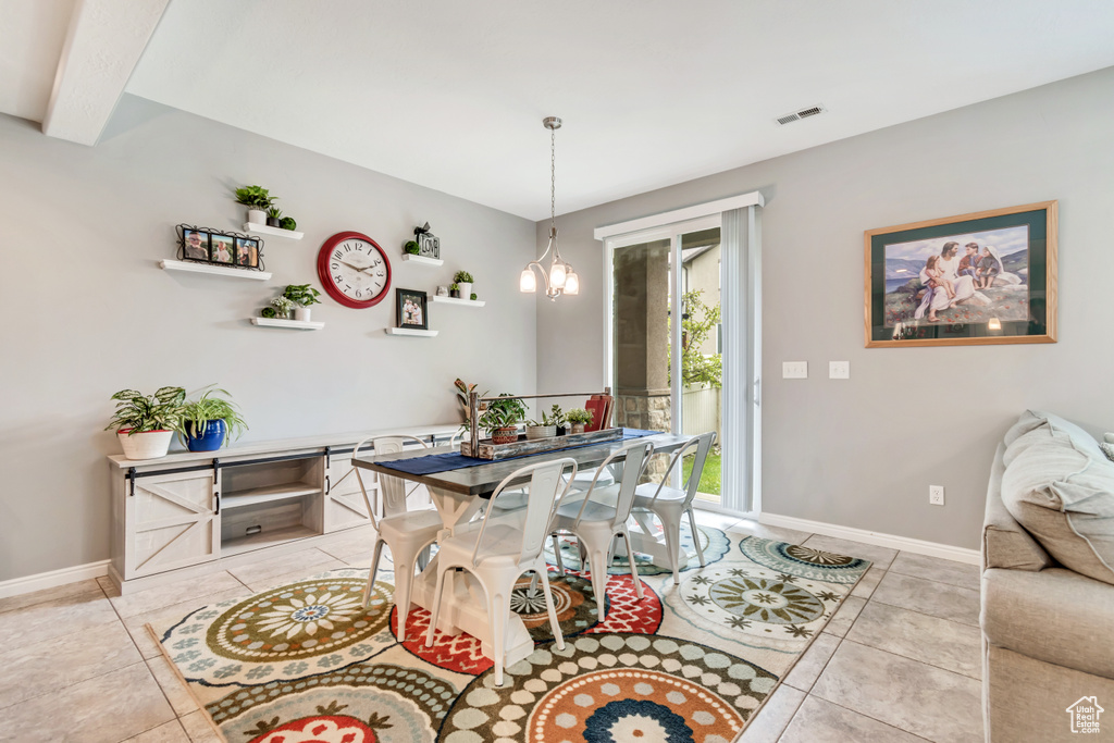 Dining space featuring light tile patterned floors and baseboards