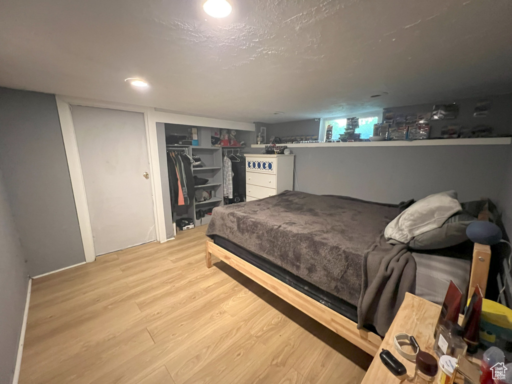 Bedroom featuring wood finished floors and a closet