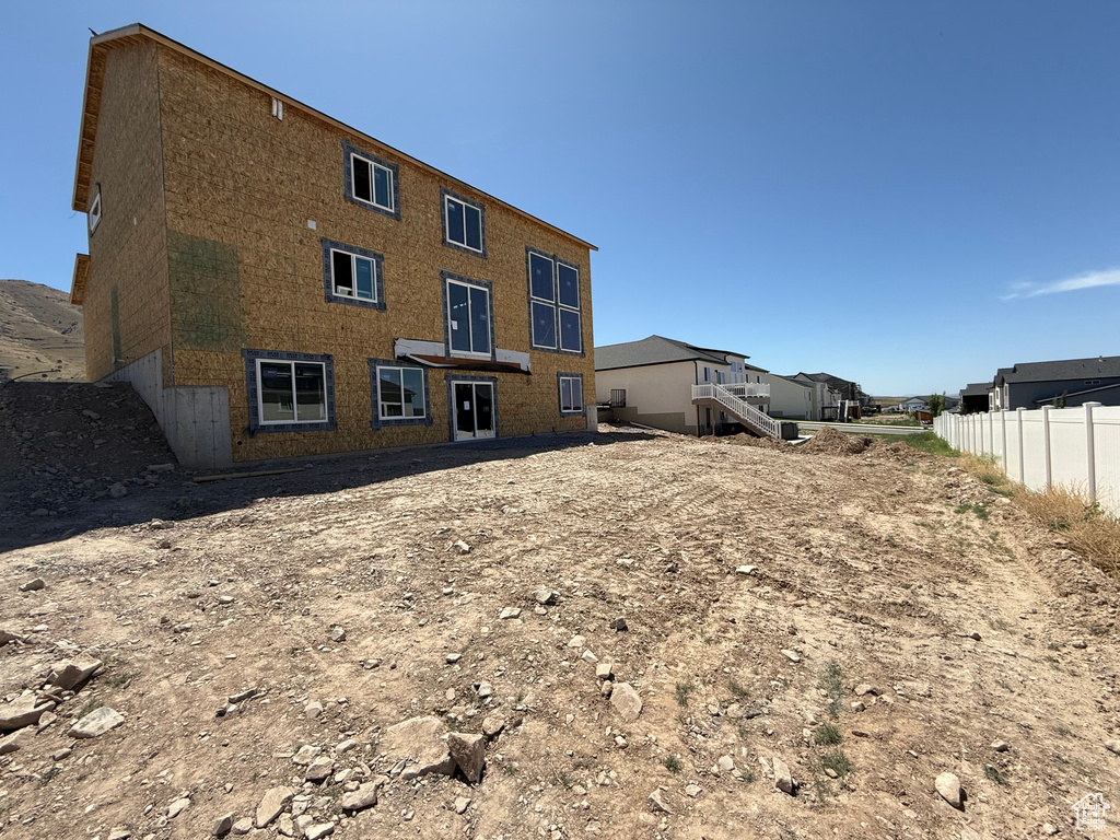 Back of house featuring brick siding