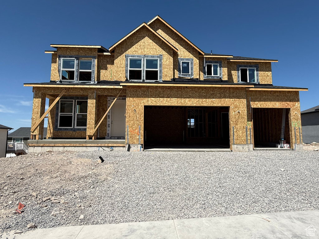 View of front facade with a garage and covered porch