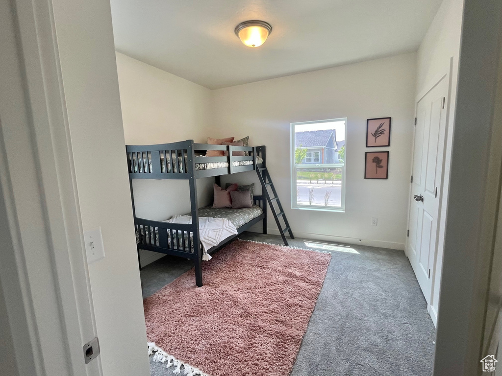 Carpeted bedroom with baseboards