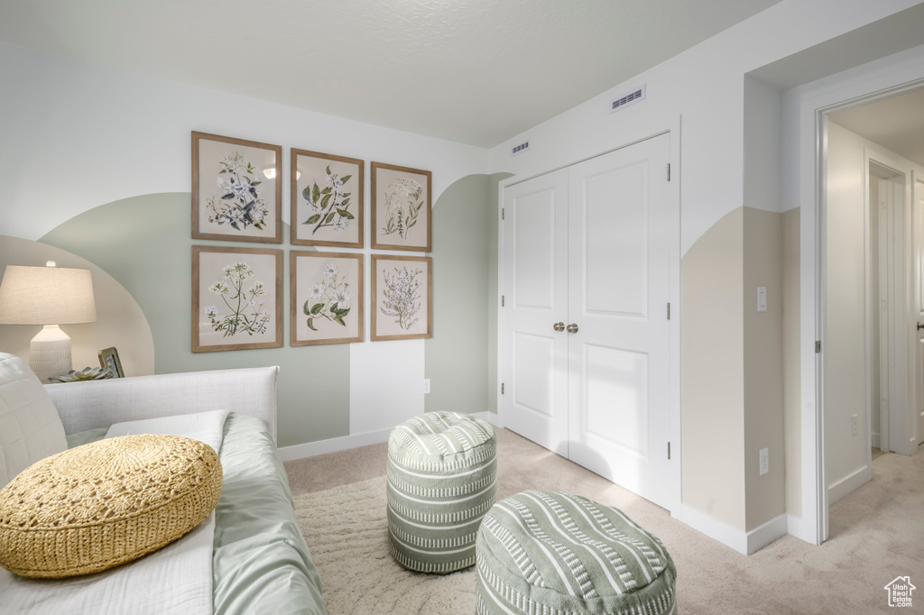 Sitting room with light colored carpet and baseboards