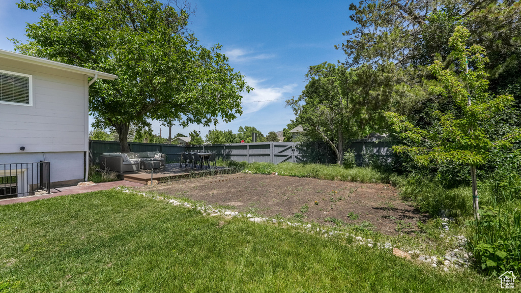 View of yard with an outdoor hangout area and a deck