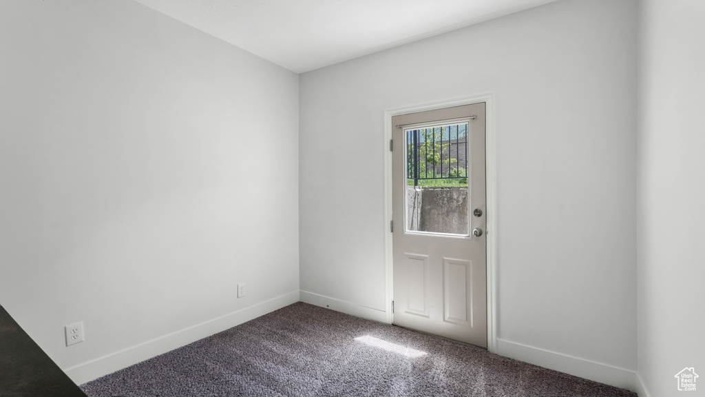 Carpeted spare room with baseboards