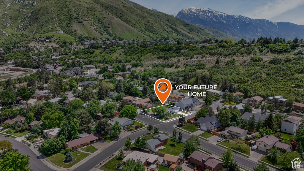 View of property location featuring a mountainous background and nearby suburban area
