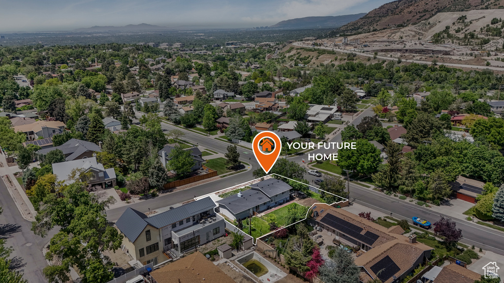 Aerial view of residential area featuring mountains and property boundaries highlighted