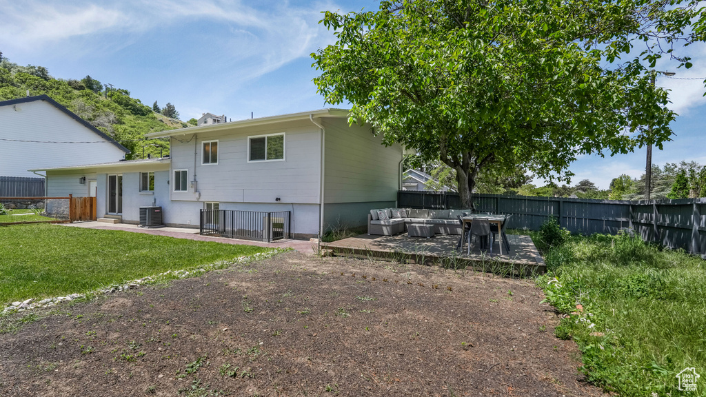 Rear view of property featuring an outdoor hangout area, central air condition unit, and a patio