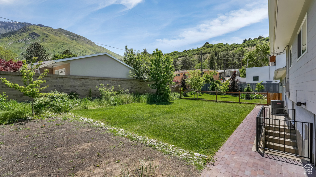 View of yard with a mountain view, cooling unit, and a patio area