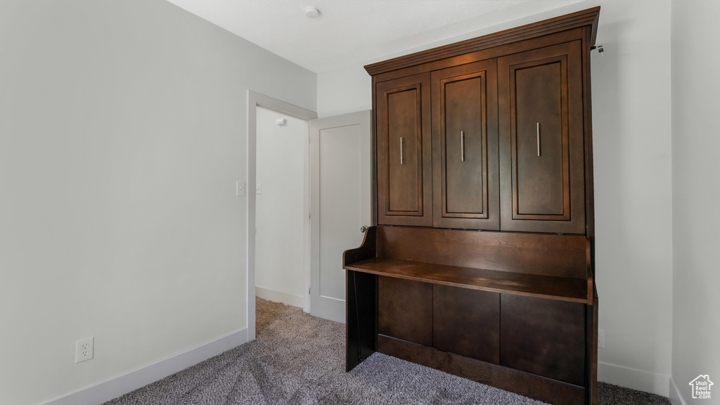 Unfurnished office featuring carpet flooring and baseboards