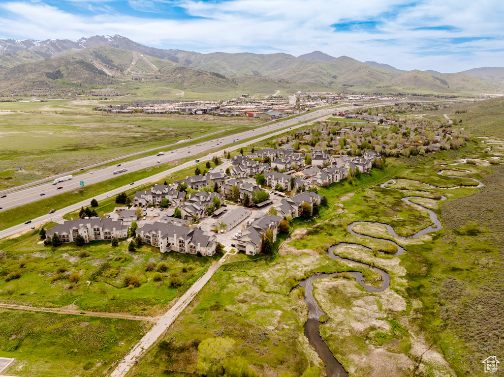 View of property location featuring mountains and nearby suburban area