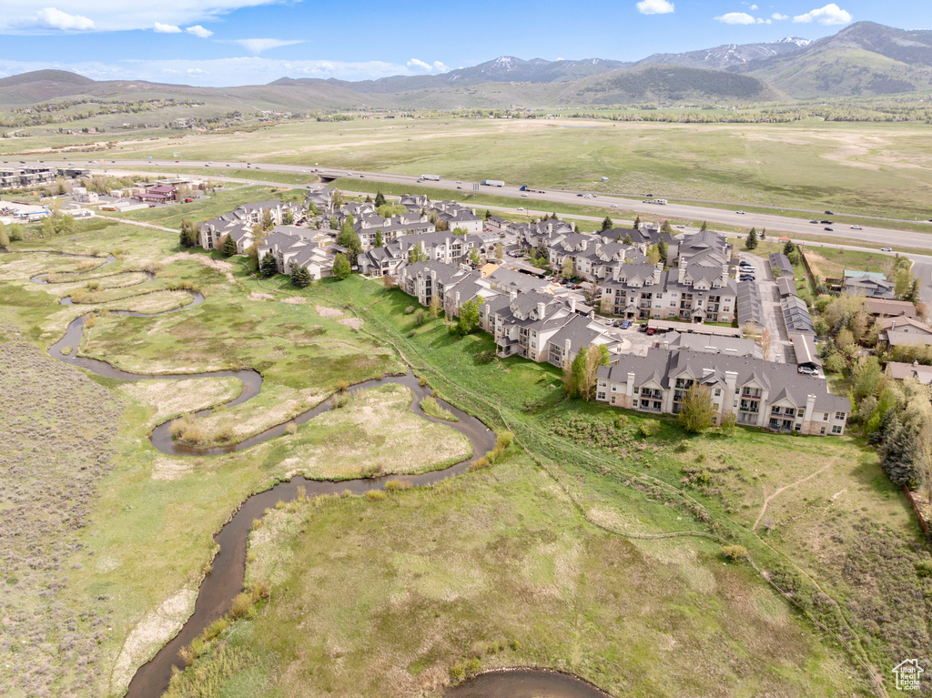 View of property location featuring mountains and nearby suburban area