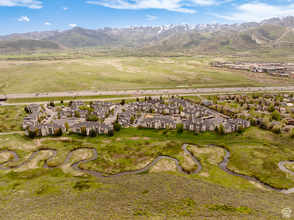 Aerial overview of property\'s location featuring nearby suburban area and a mountainous background