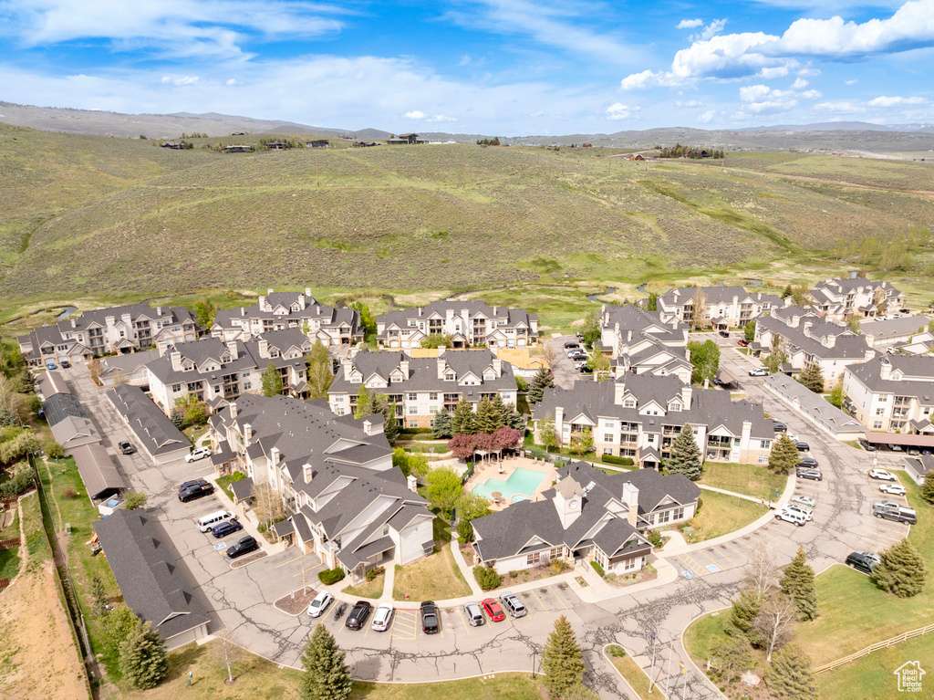 Aerial view of property and surrounding area with nearby suburban area