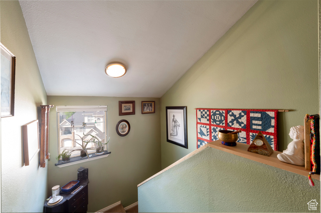 Bedroom featuring vaulted ceiling and baseboards