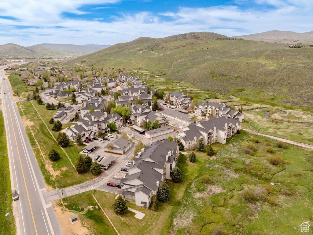 Aerial overview of property\'s location featuring nearby suburban area and a mountainous background