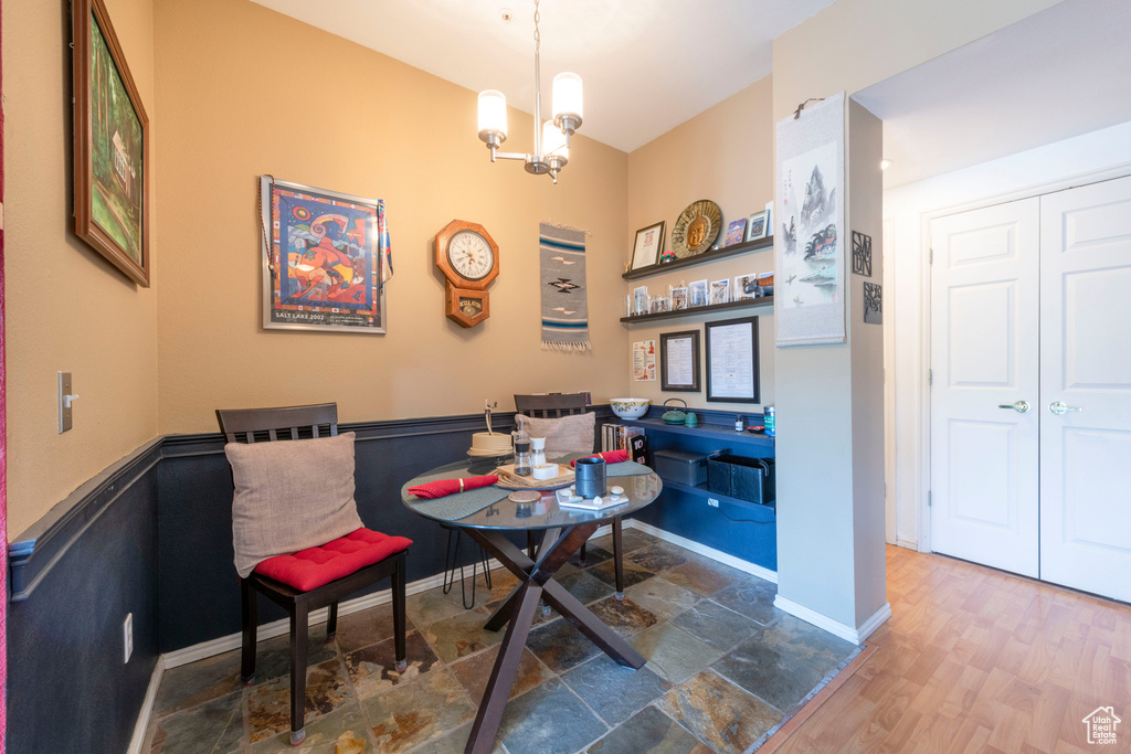 Dining space featuring a chandelier, baseboards, and wood finished floors