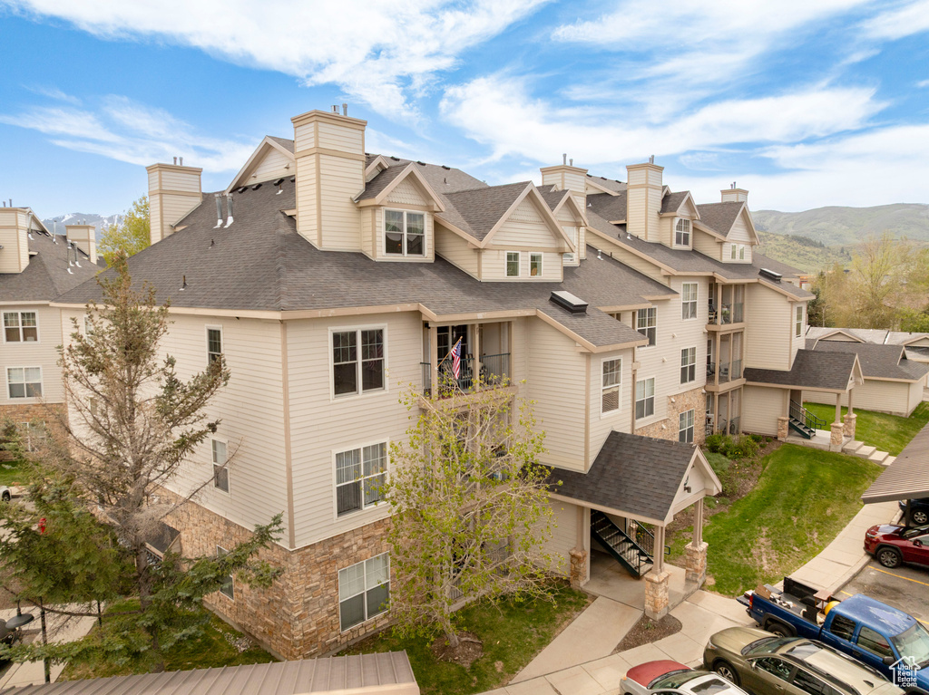 View of property featuring a residential view, stairs, and a mountain view