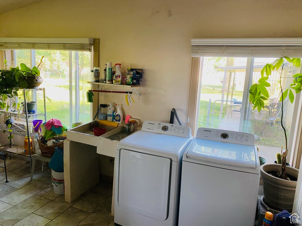 Washroom with independent washer and dryer and stone finish floors