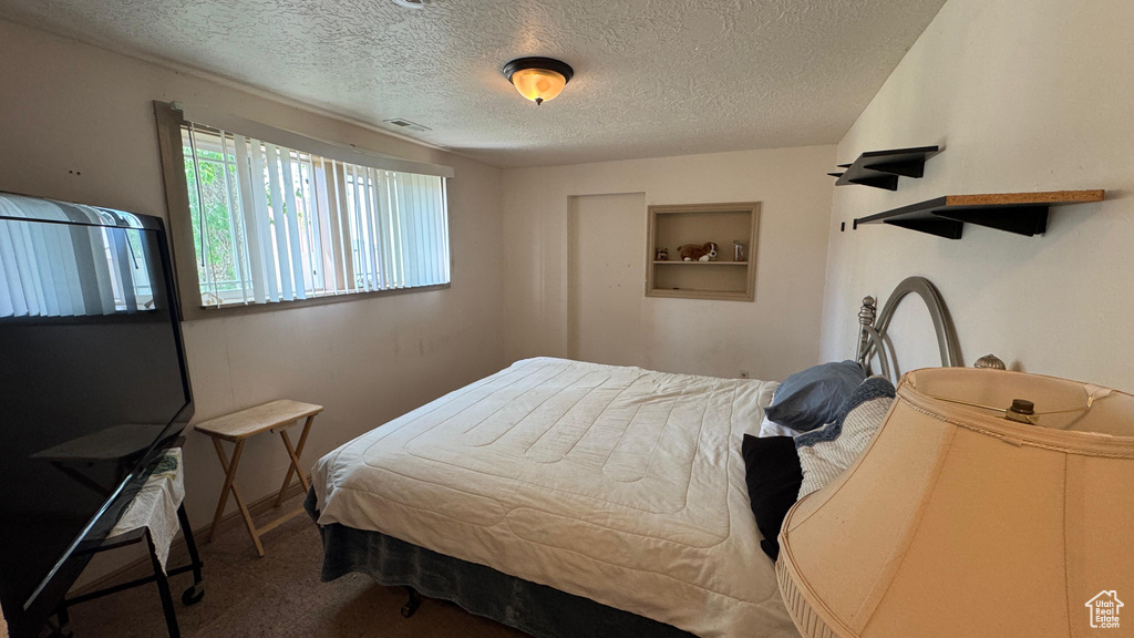 Bedroom featuring a textured ceiling