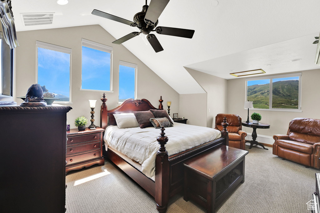 Bedroom featuring light carpet, lofted ceiling, a ceiling fan, and baseboards