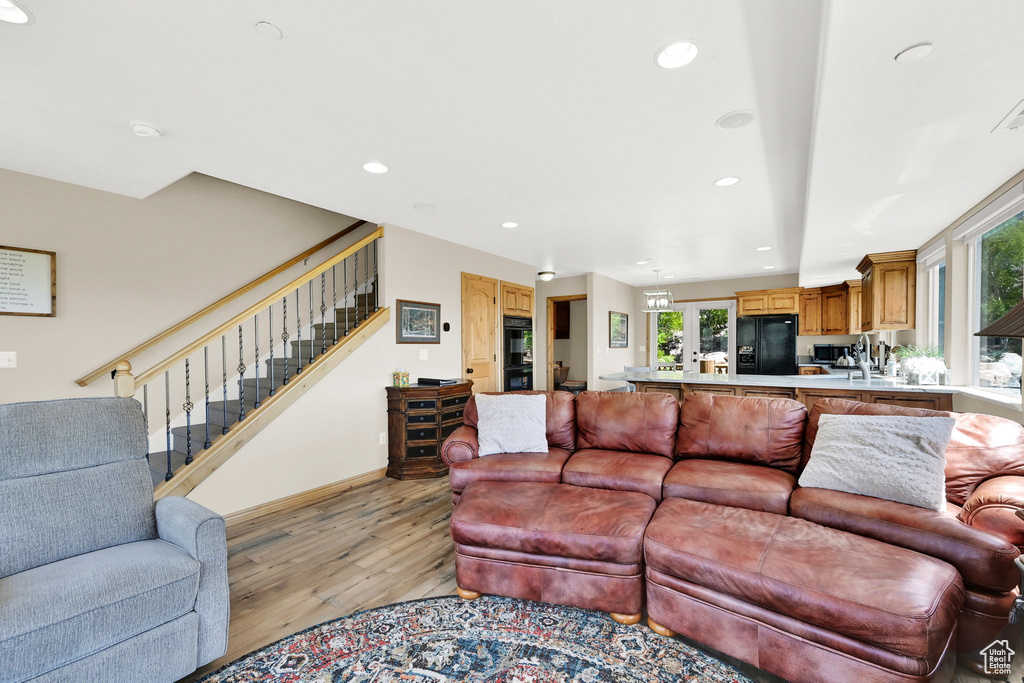 Living room featuring light wood finished floors, stairway, recessed lighting, and baseboards